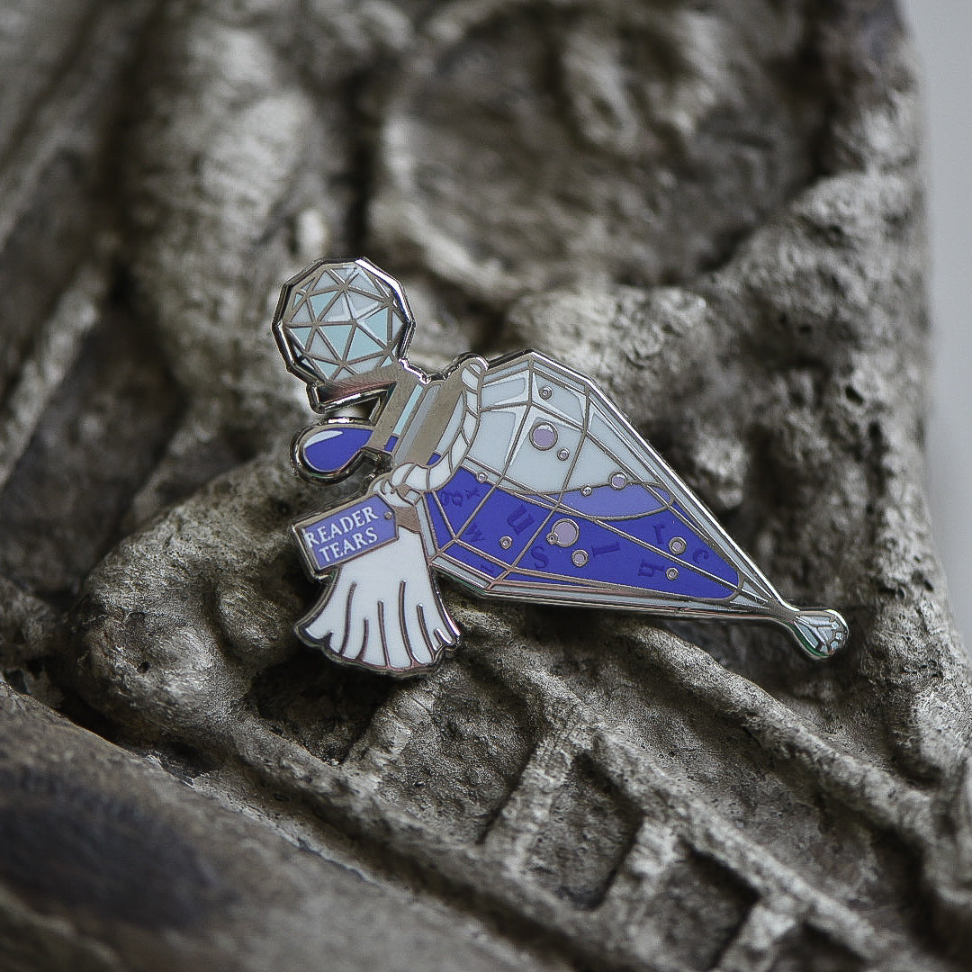 Purple and silver potion bottle enamel pin with a tag that says Reader Tears