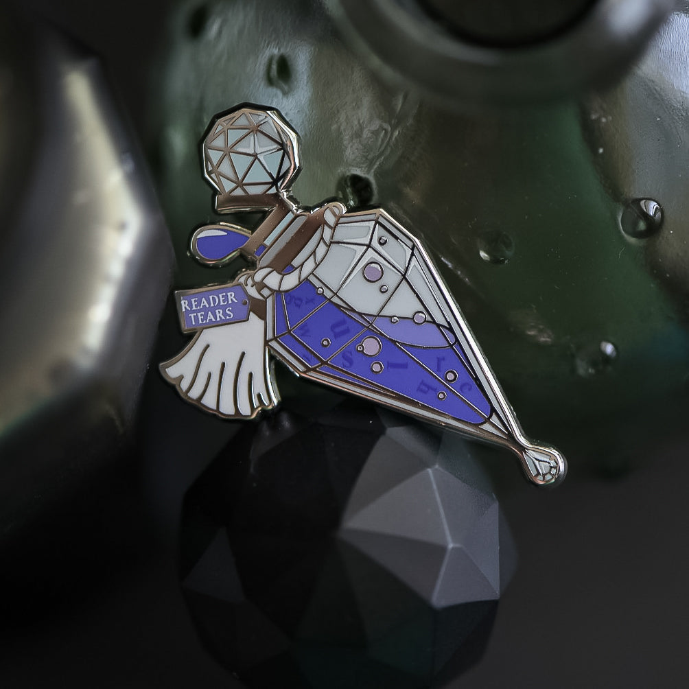 Purple and silver ornate potion bottle enamel pin with a tag that says Reader Tears