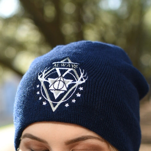 Blue white and gray deathly hallows symbol embroidered on a navy beanie