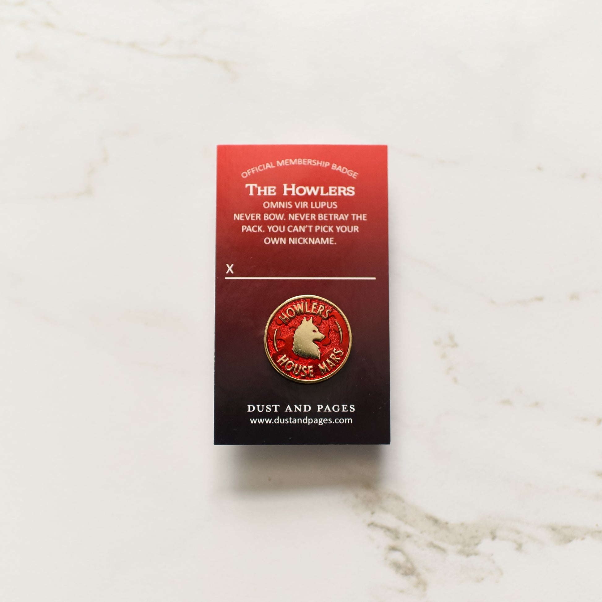 Red and gold circle membership style enamel pin with a wolf and howler house mars text on a red and black gradient card