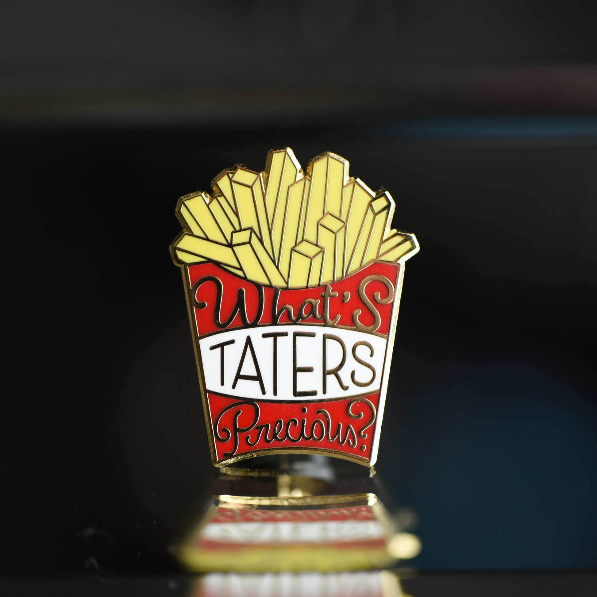 Red box of fries gold enamel pin that says What's Taters Precious
