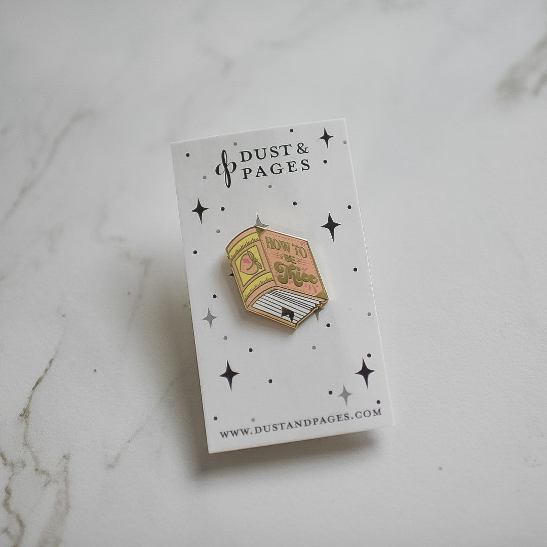 Peach and gold metal book enamel pin with the title How to be Thicc