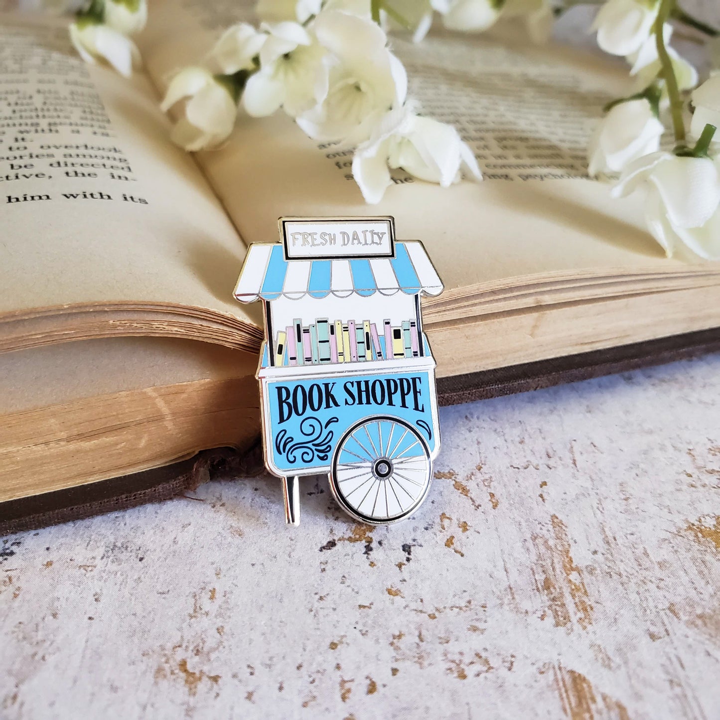 Pastel color enamel pin on a open book