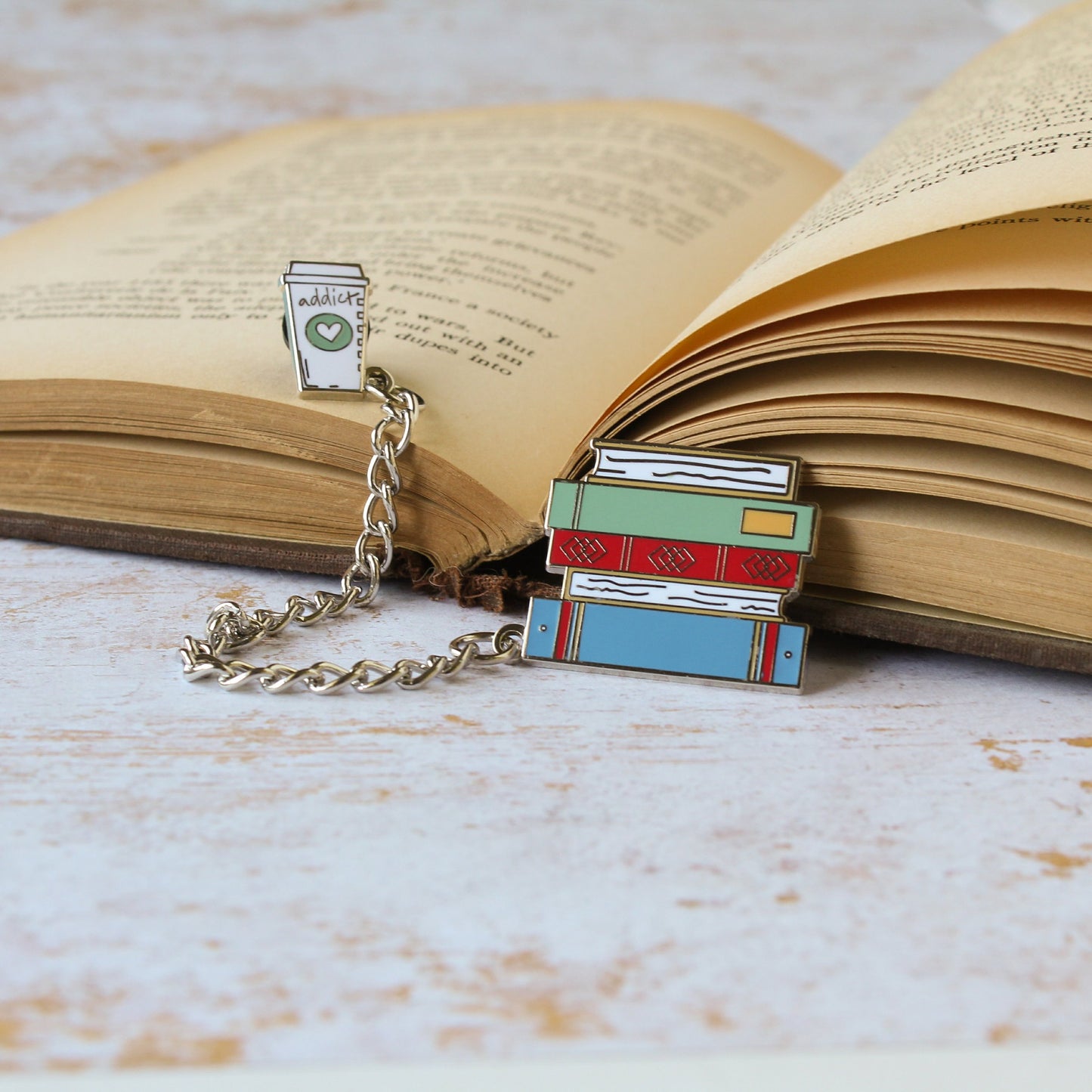 Stack of books and coffee cup on an open book