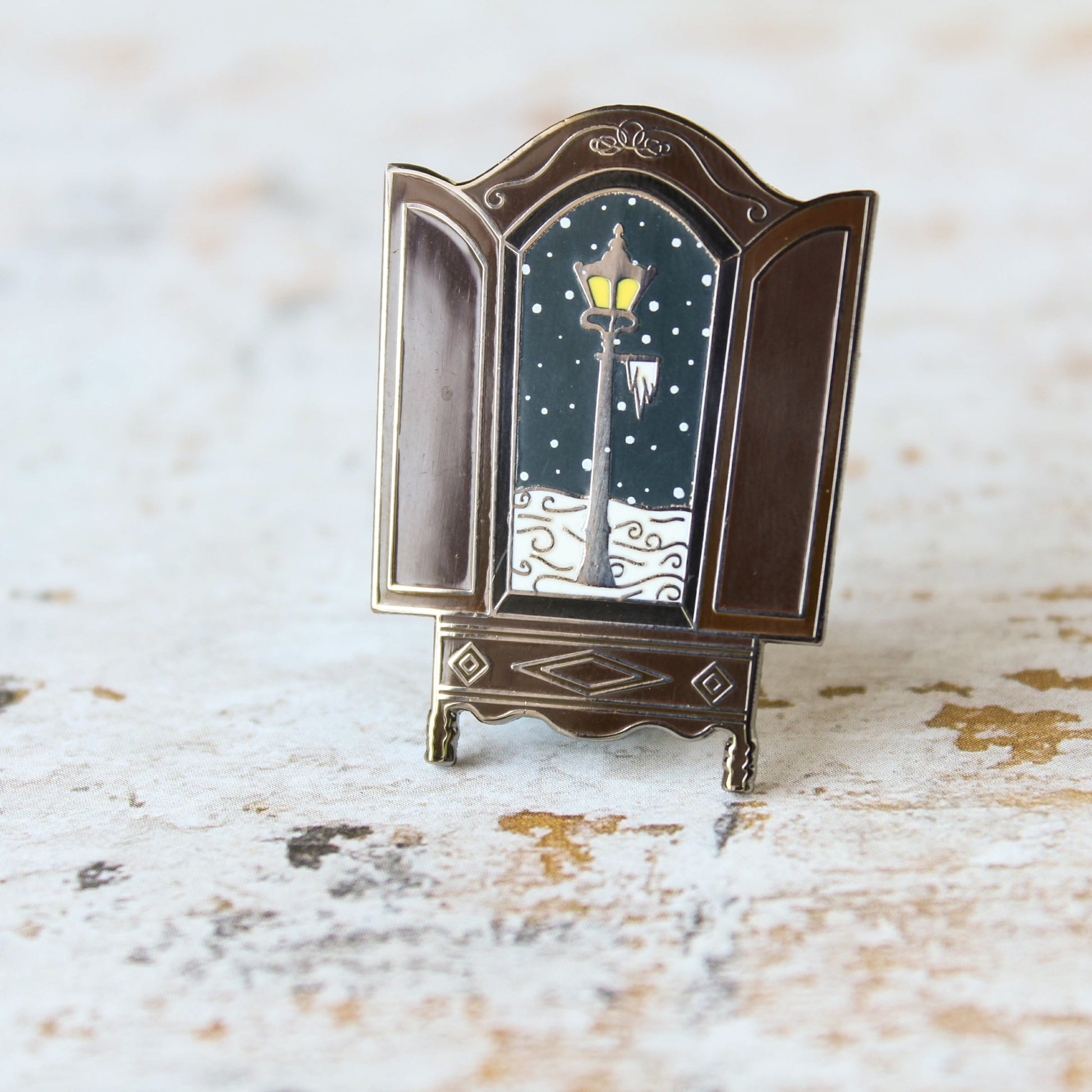 The lion the witch and the wardrobe snowy lantern in the wardrobe narnian enamel pin
