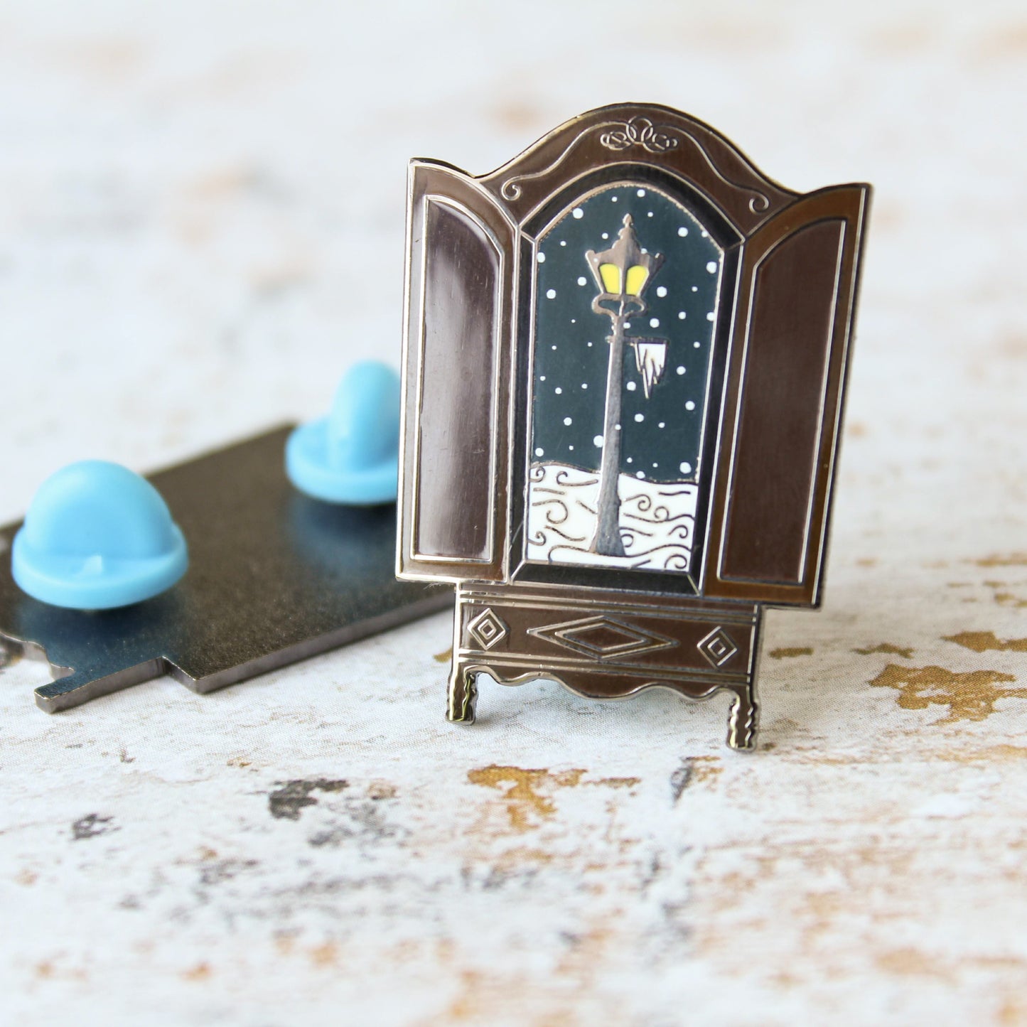 The lion the witch and the wardrobe snowy lantern in the wardrobe narnian enamel pin