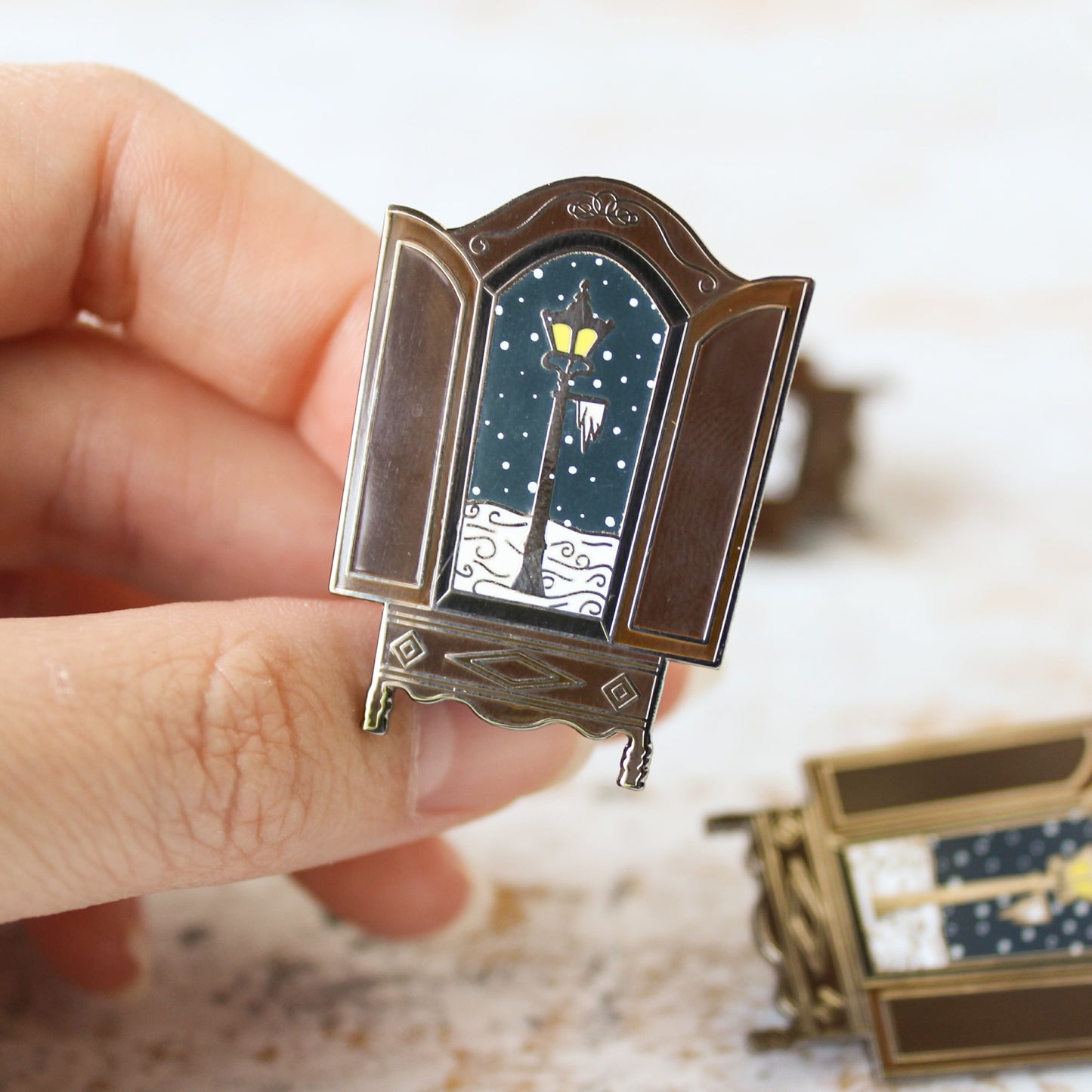 The lion the witch and the wardrobe snowy lantern in the wardrobe narnian enamel pin